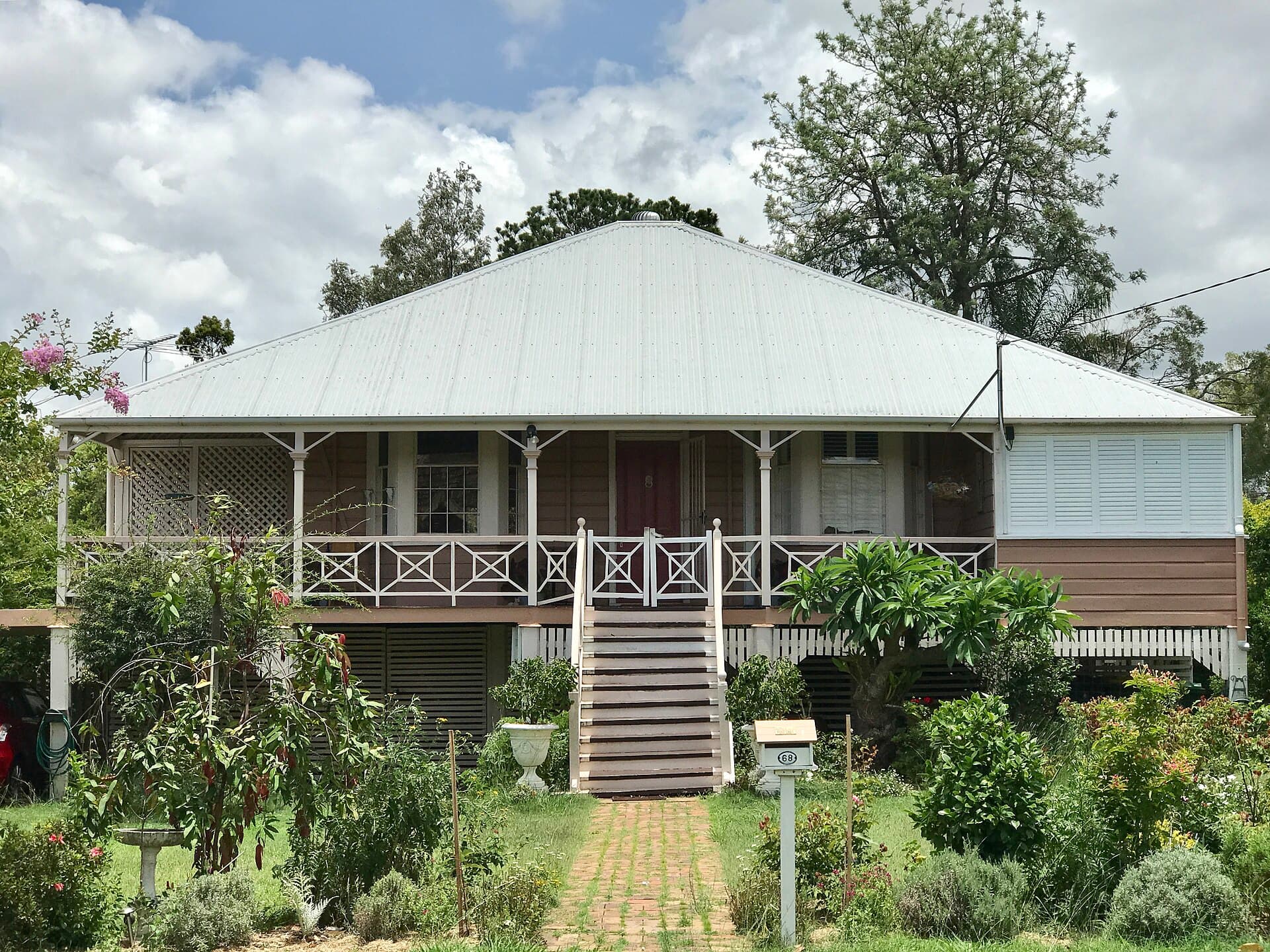 A timber house with a tiled roof in Chelmer, where restoration and replacement are both live options